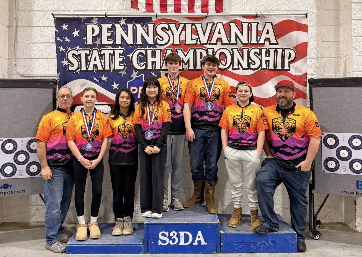 The LPRGC S3DA team and their coaches on the podium at the Pennsylvania State Championship, wearing team jerseys and medals.